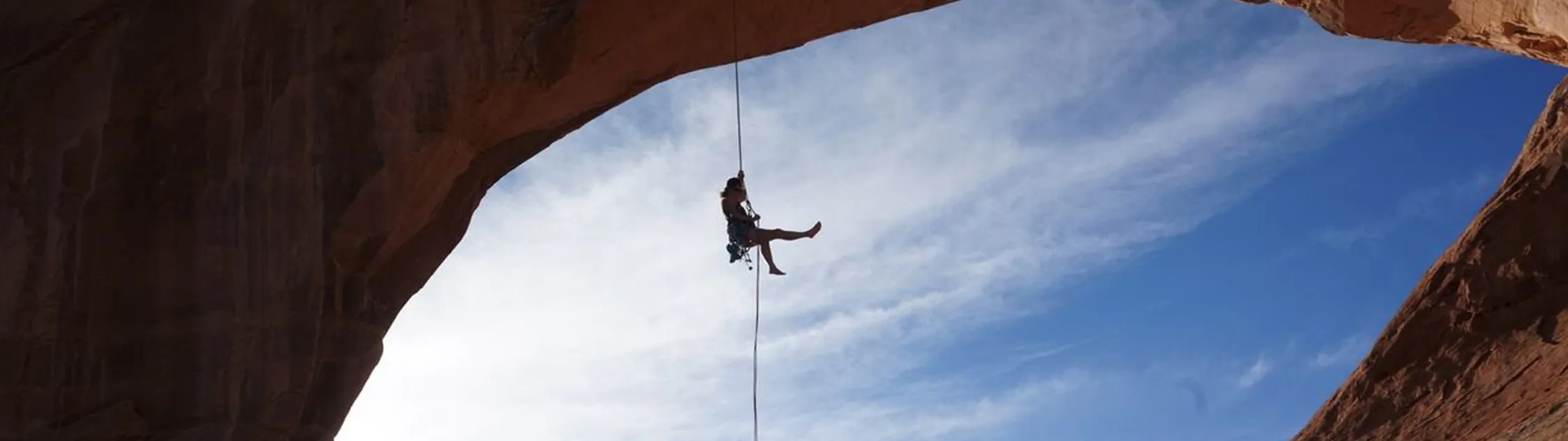 Panoramic Image of Alexandra Price, Viridien geologist, climbing a mountain