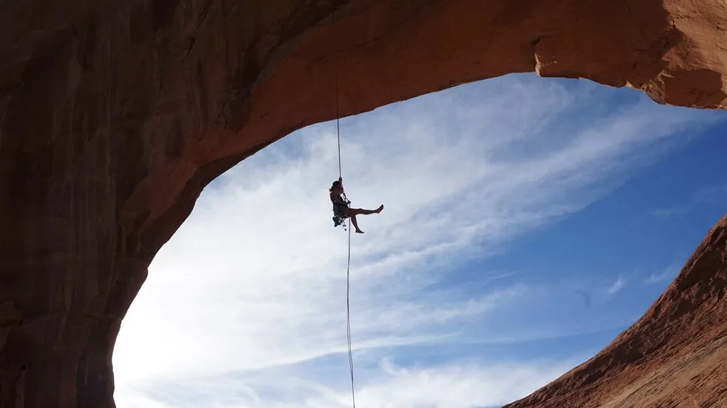 Image of Alexandra Price, Viridien geologist, climbing a mountain